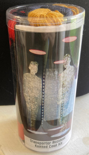 Knitted cowl kit in a clear cylindrical container