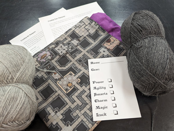 Project bag, contrast yarns, instructions, and character sheet
